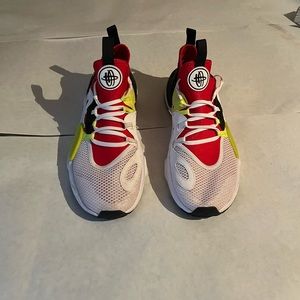 Red white and light green Nike running shoes